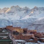 Snow-covered Atlas Mountains with Berber village and terraced fields in winter