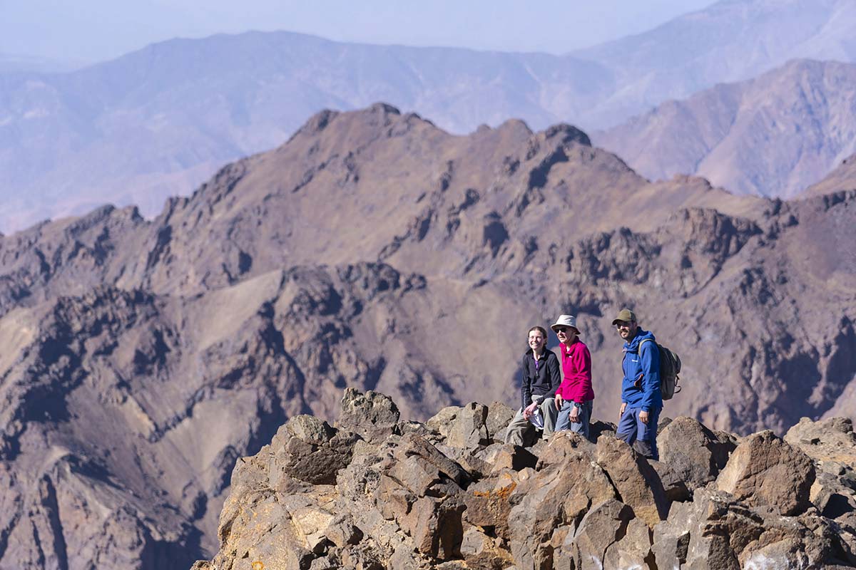 Hikers on a rocky ridge during a Mount Toubkal trek in the High Atlas Mountains, Morocco