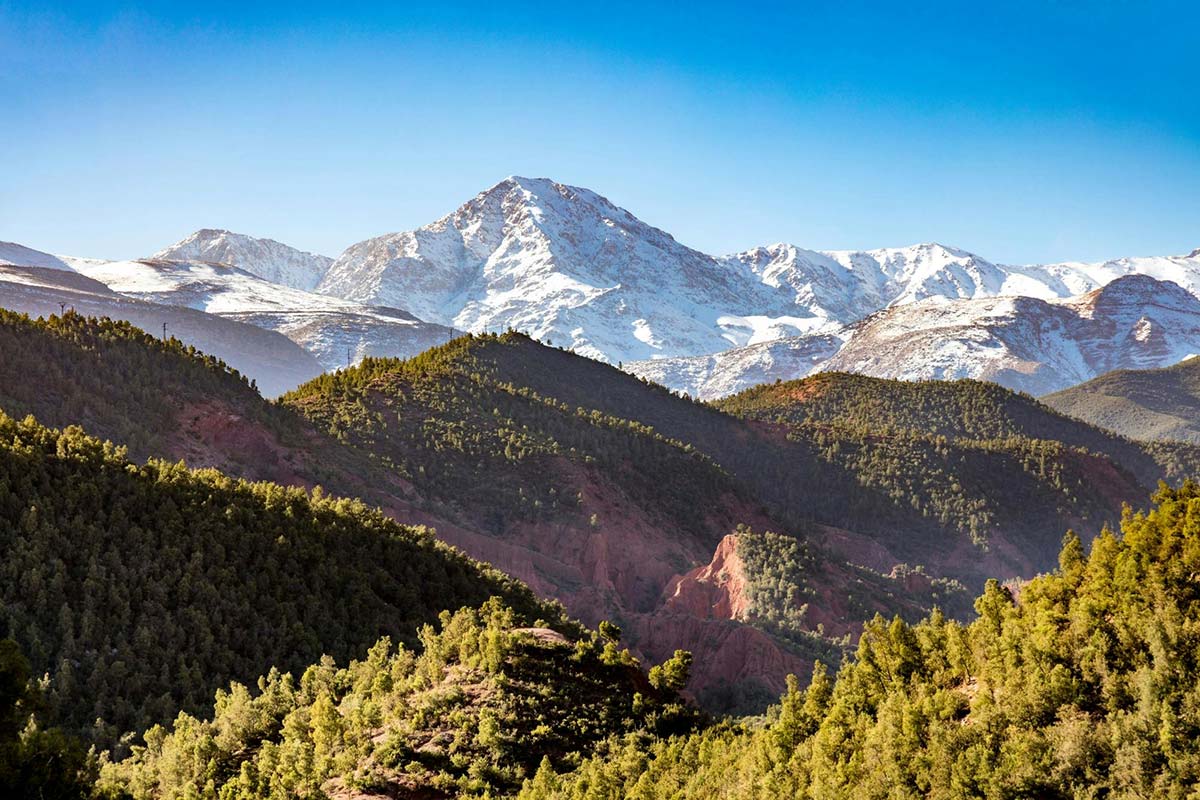 Snow-capped High Atlas peaks with forests, valleys and mountain scenery in Morocco